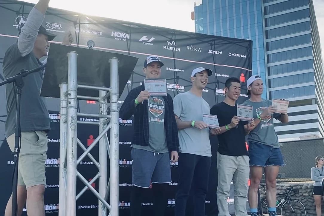 Dylan with other age-group finishers on the Ironman Arizona awards stage.