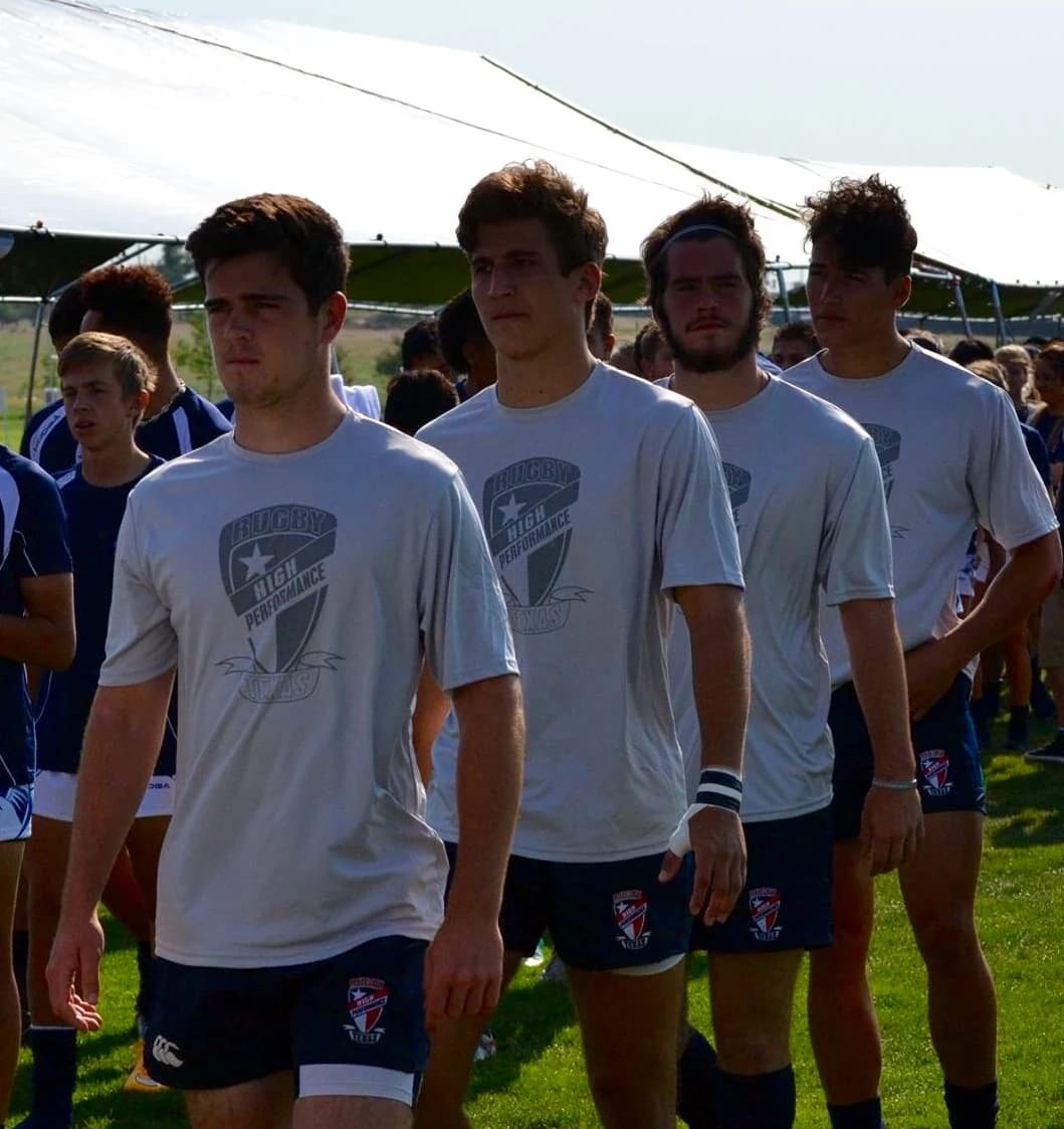 Rugby Texas High Performance players walk out in team shirts before a match.